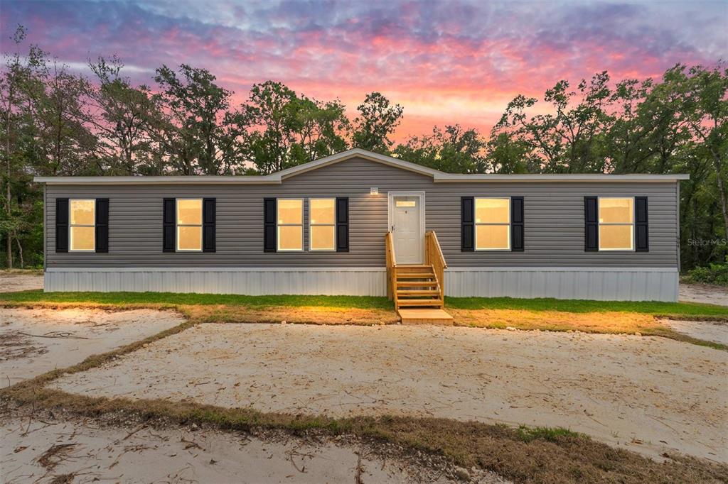 664 Boundary Street Bronson, FL 32621 - Photo 1 of 1 a view of a house with a swimming pool and a yard