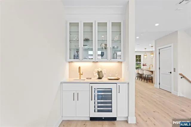 a view of kitchen with wooden floor and cabinets