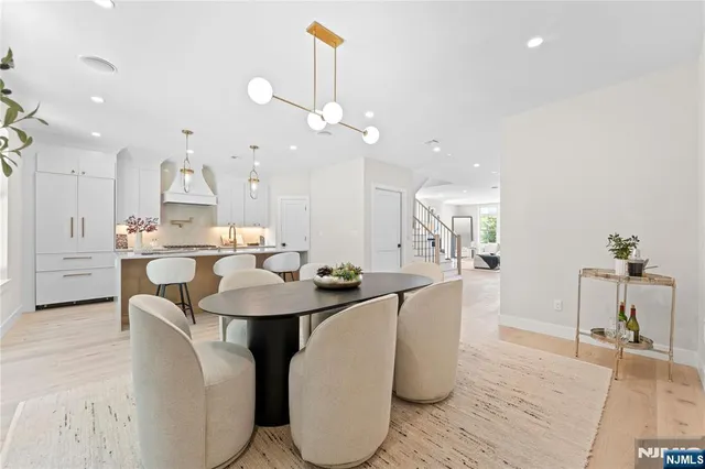 a large kitchen with a table and chairs