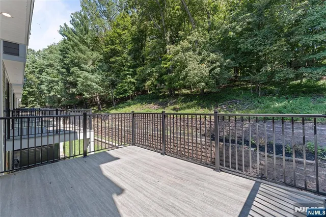 a balcony with wooden floor and fence