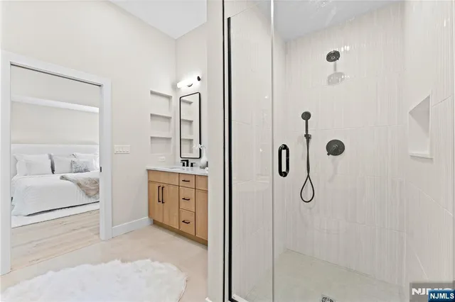 a spacious bathroom with a shower and a sink