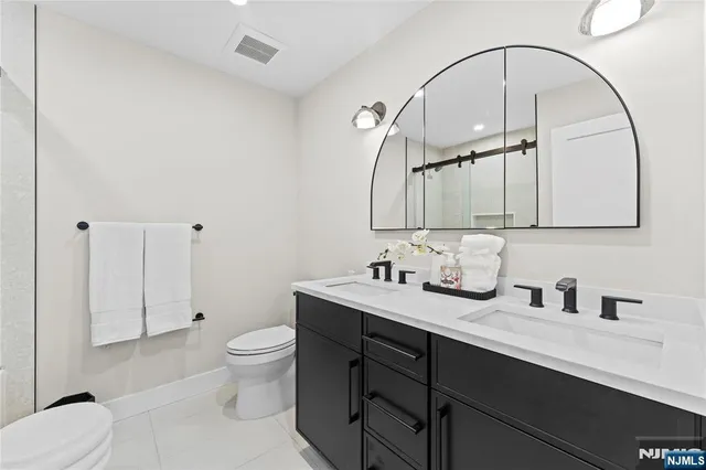 a bathroom with a toilet a sink and mirror