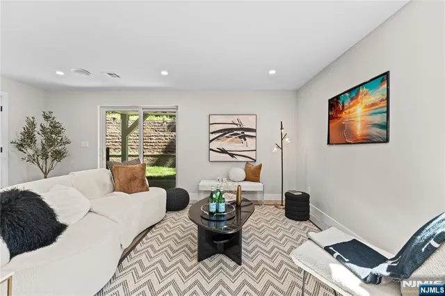 a bedroom with furniture and a large window