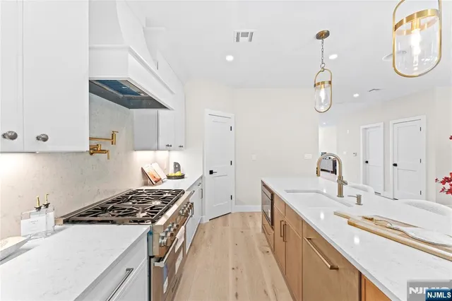 a kitchen with a sink and a stove top oven