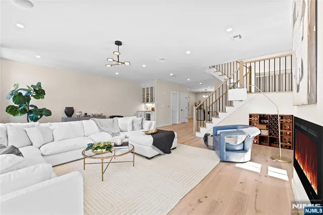 a living room with furniture and a chandelier