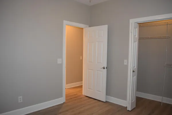 a view of an empty room with wooden floor