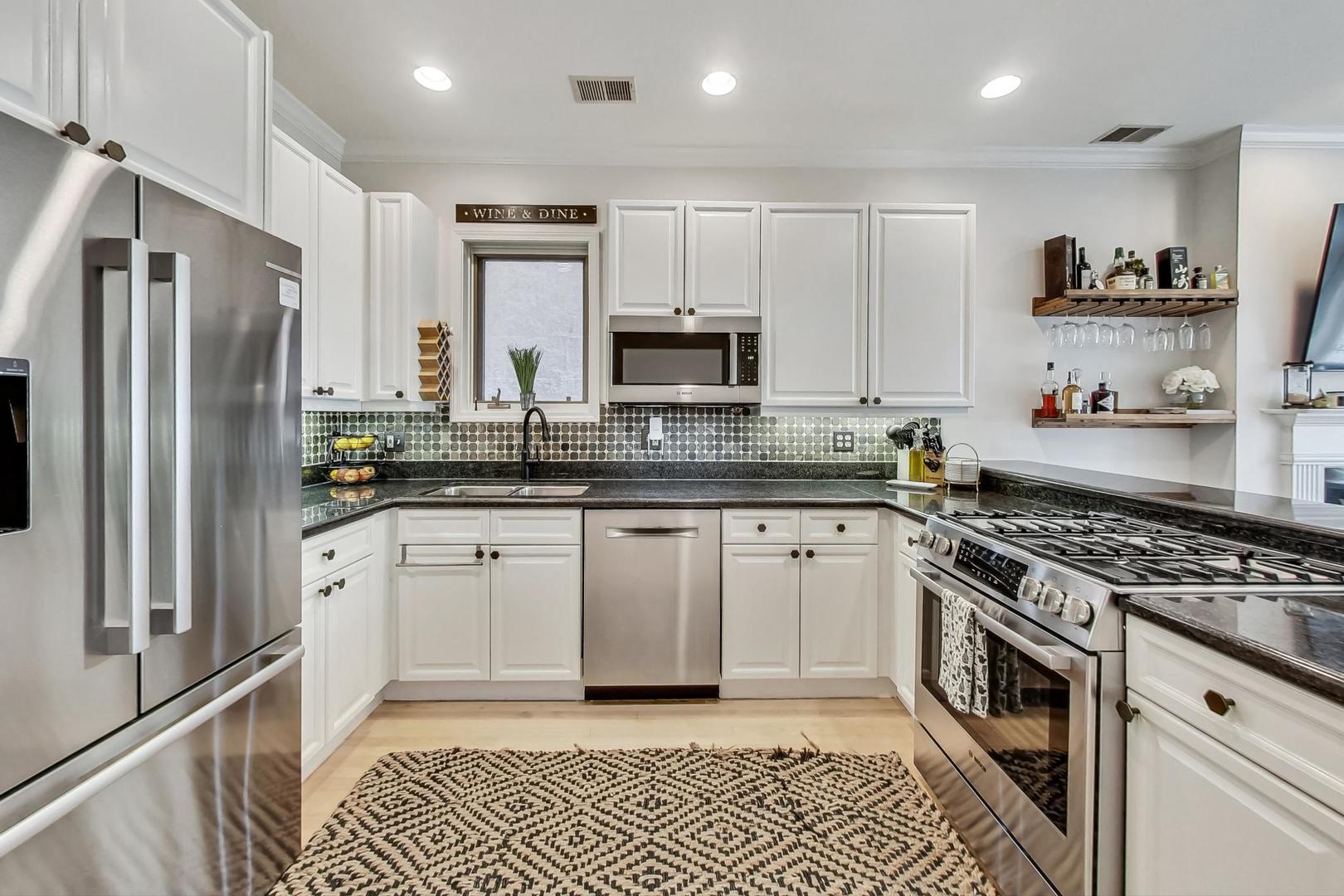 952 West Barry Avenue, Unit 2 Chicago, IL 60657 - Photo 11 of 24 a kitchen with stainless steel appliances granite countertop a stove a sink and a refrigerator