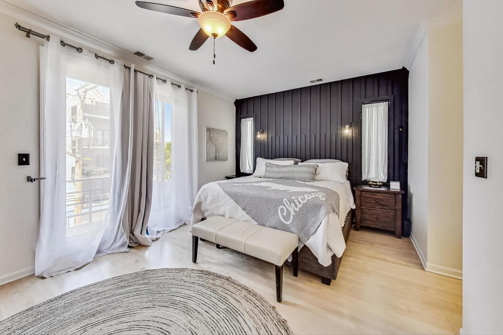 952 West Barry Avenue, Unit 2 Chicago, IL 60657 - Photo 13 of 24 a bedroom with a large bed and a chandelier