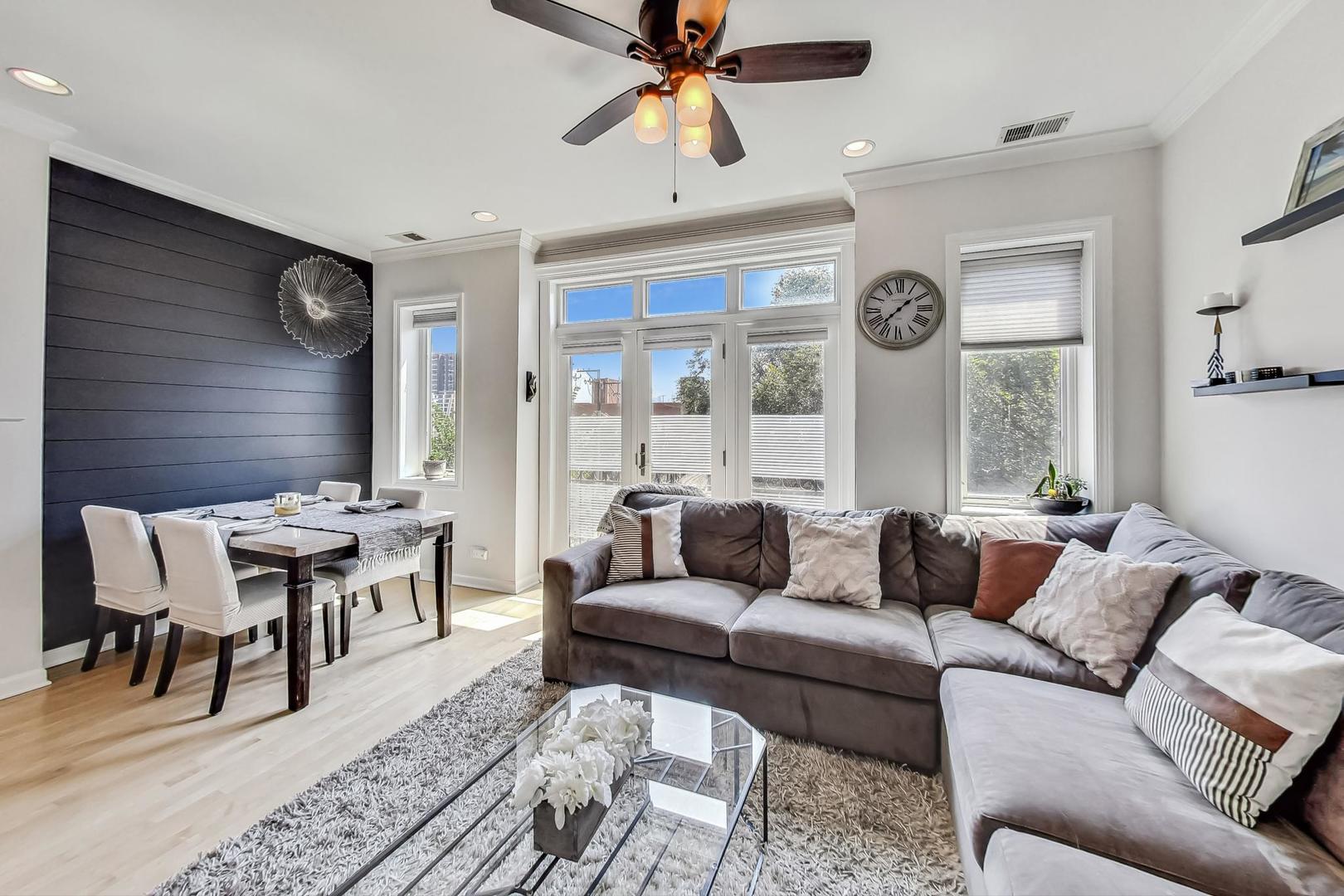 952 West Barry Avenue, Unit 2 Chicago, IL 60657 - Photo 2 of 24 a living room with furniture and a large window