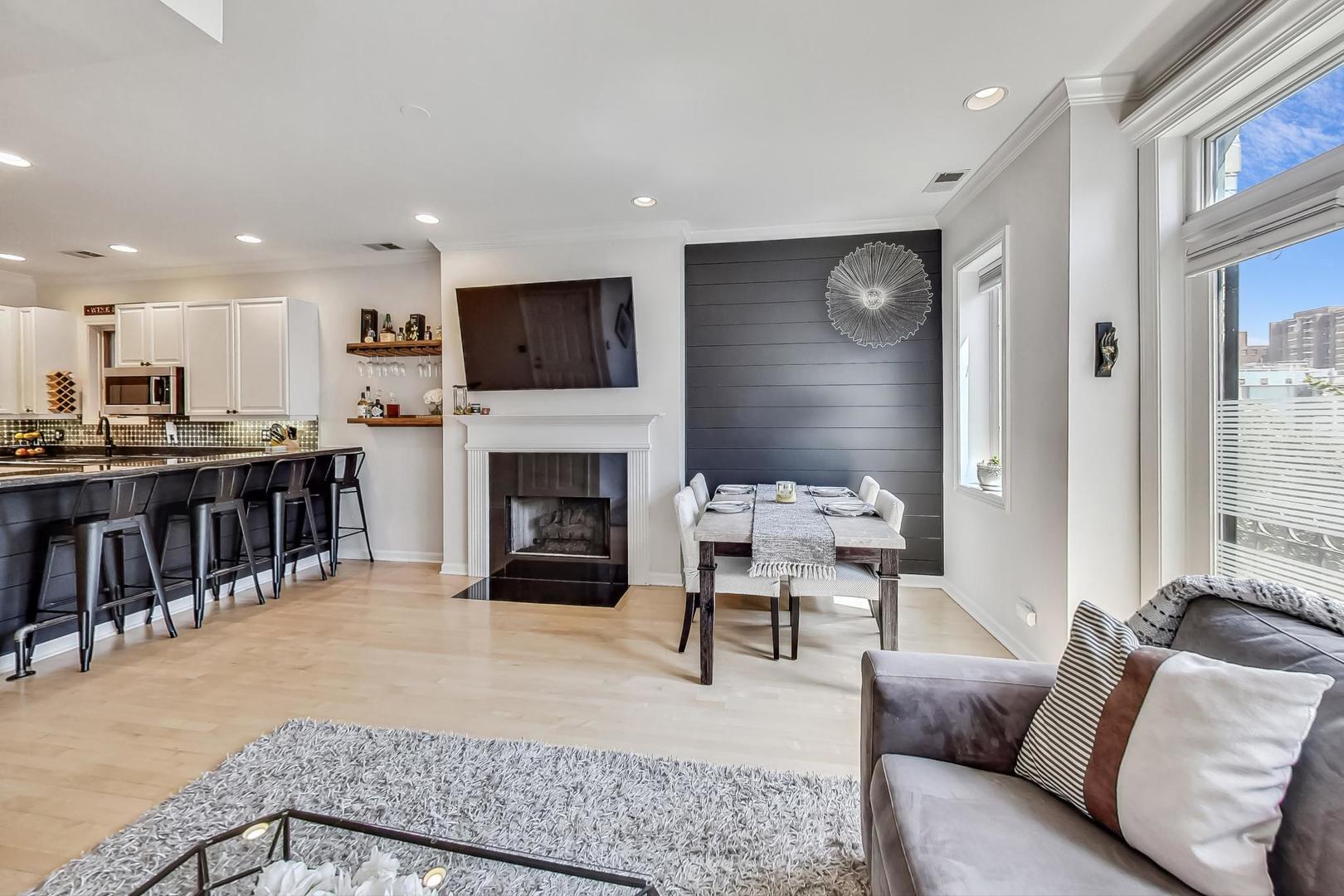 952 West Barry Avenue, Unit 2 Chicago, IL 60657 - Photo 3 of 24 a living room with furniture a fireplace and a flat screen tv