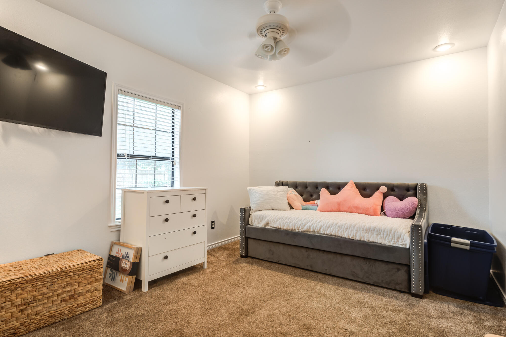 4510 21st Street Lubbock, TX 79407 - Photo 11 of 17 a bedroom with a bed and a flat tv screen on dresser