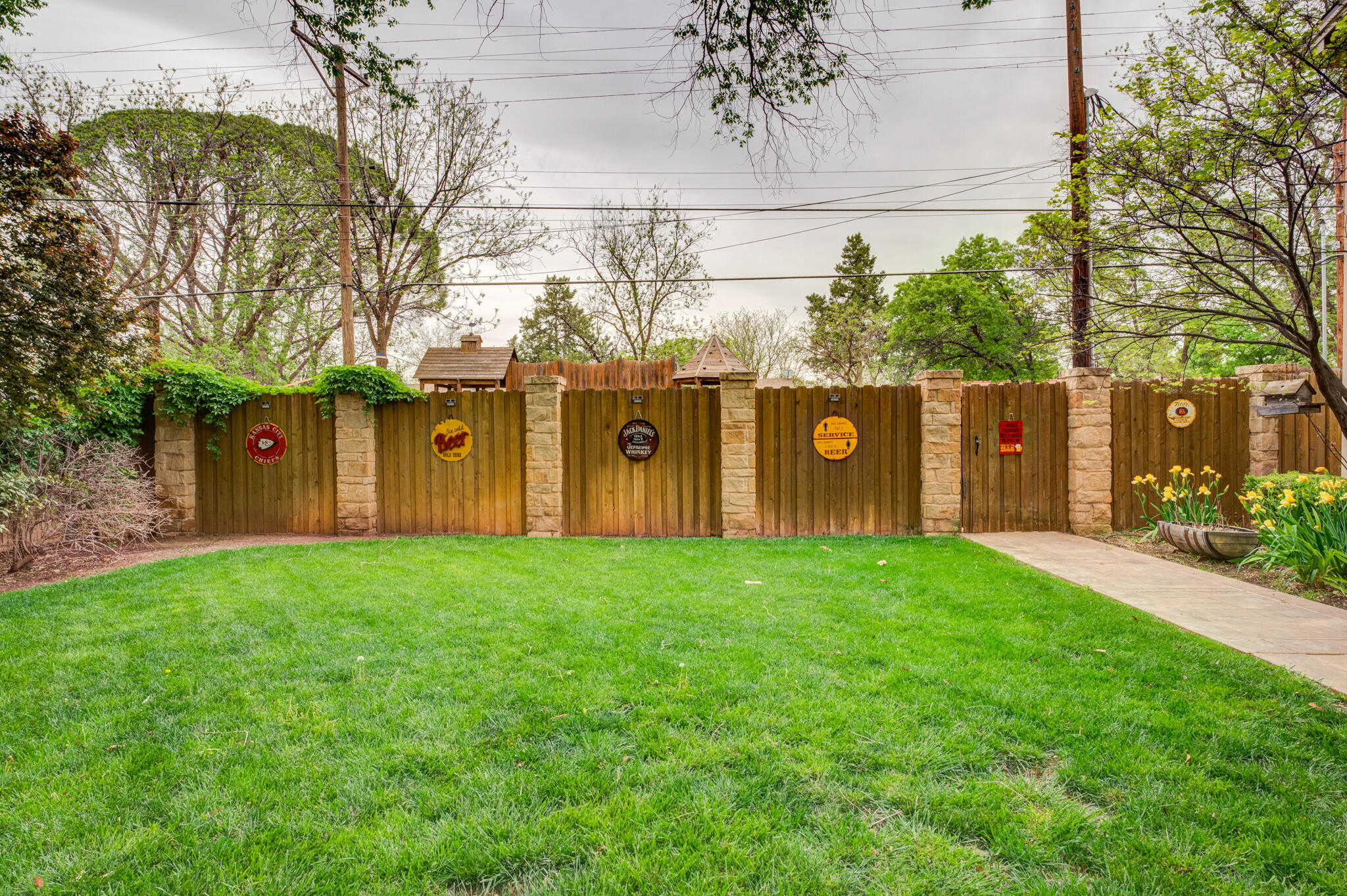 4510 21st Street Lubbock, TX 79407 - Photo 13 of 17 a view of a backyard with potted plants and large trees