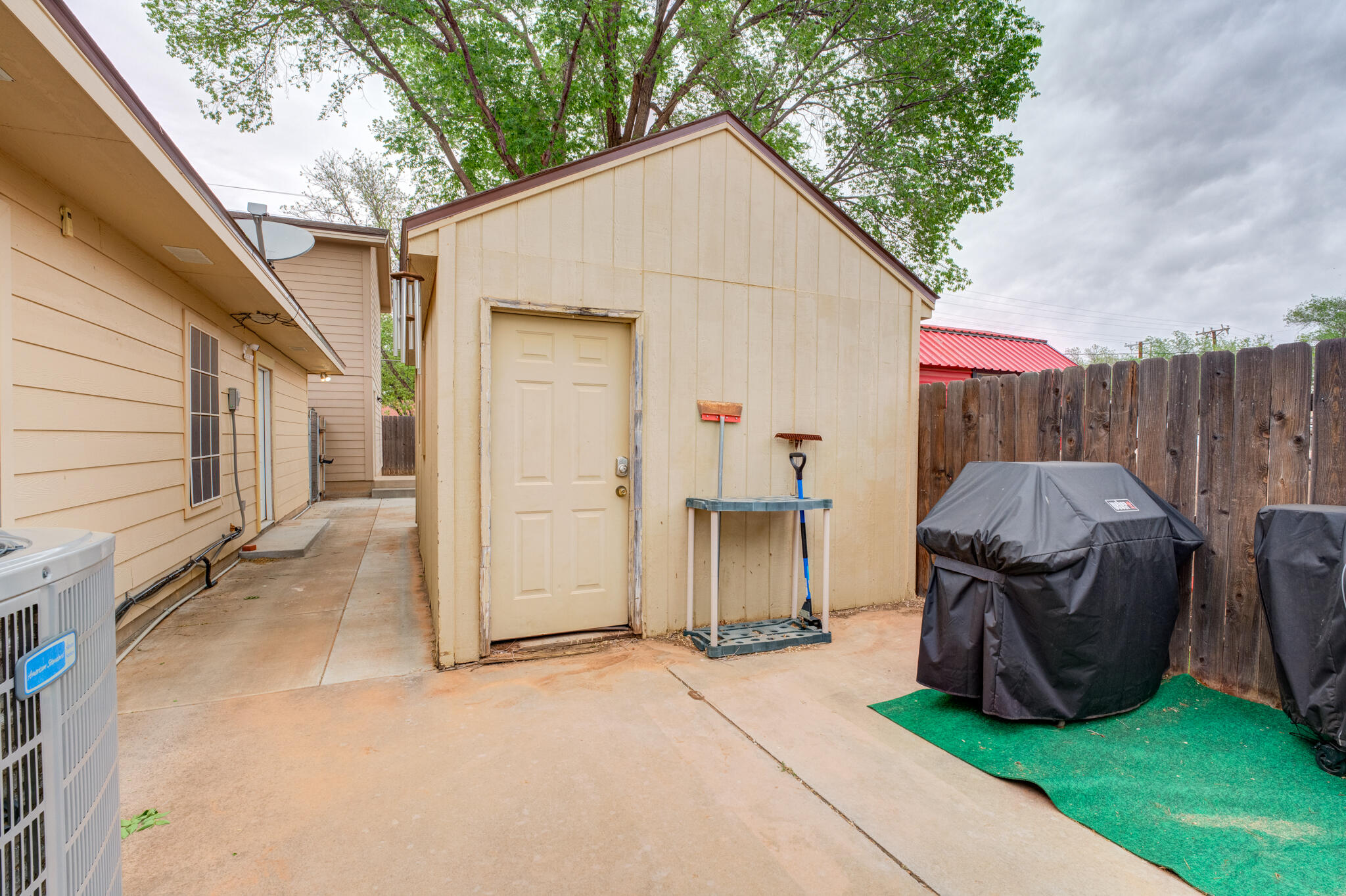 4510 21st Street Lubbock, TX 79407 - Photo 16 of 17 a view of a small house with backyard and a large tree