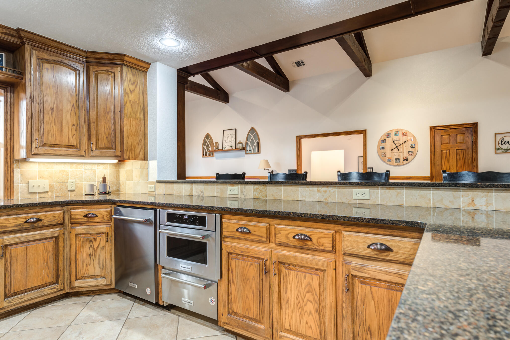 4510 21st Street Lubbock, TX 79407 - Photo 5 of 17 a kitchen with granite countertop white cabinets and white appliances