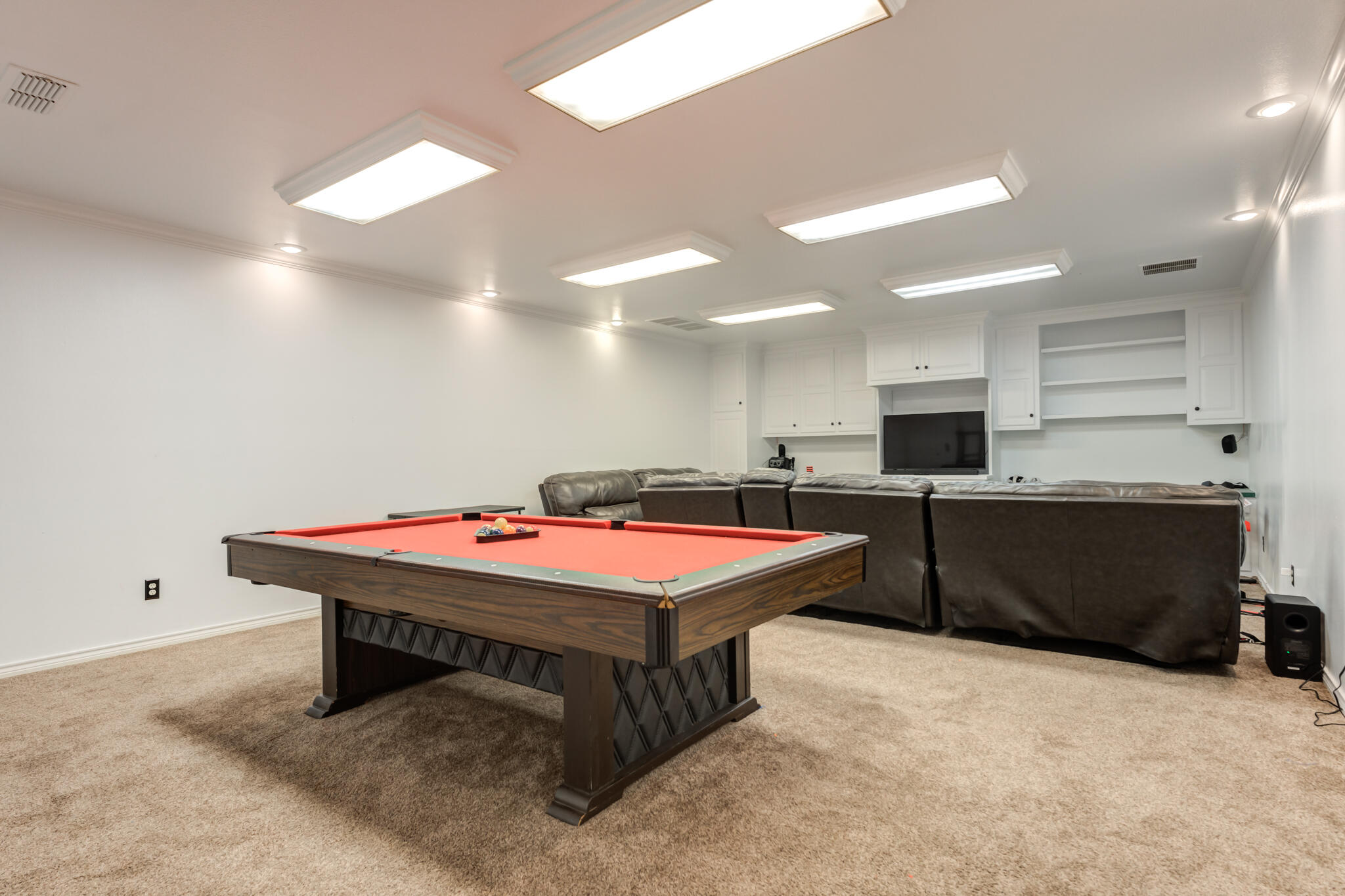 4510 21st Street Lubbock, TX 79407 - Photo 6 of 17 a room with pool table and flat screen tv