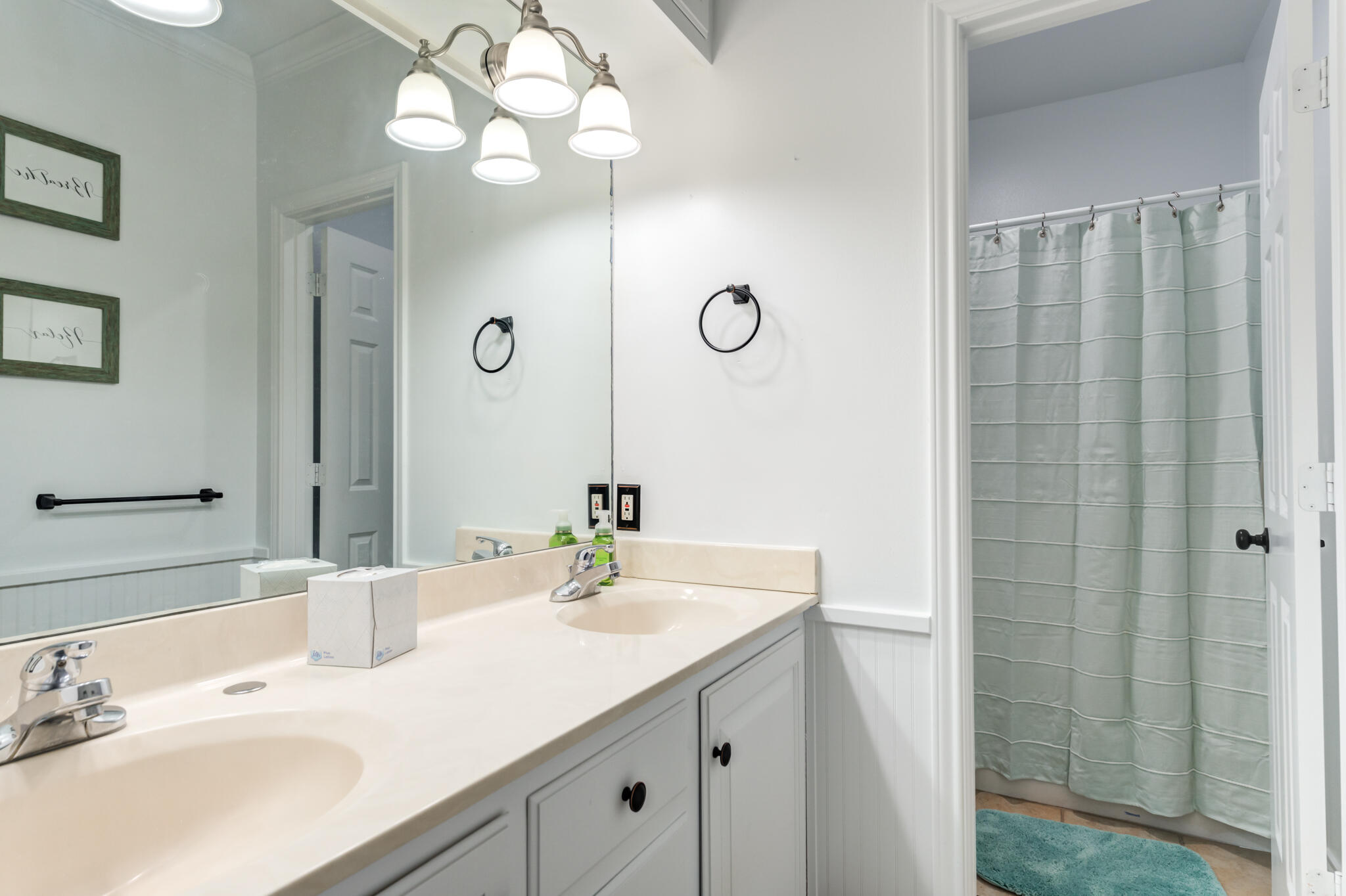 4510 21st Street Lubbock, TX 79407 - Photo 10 of 17 a bathroom with a sink vanity and a mirror