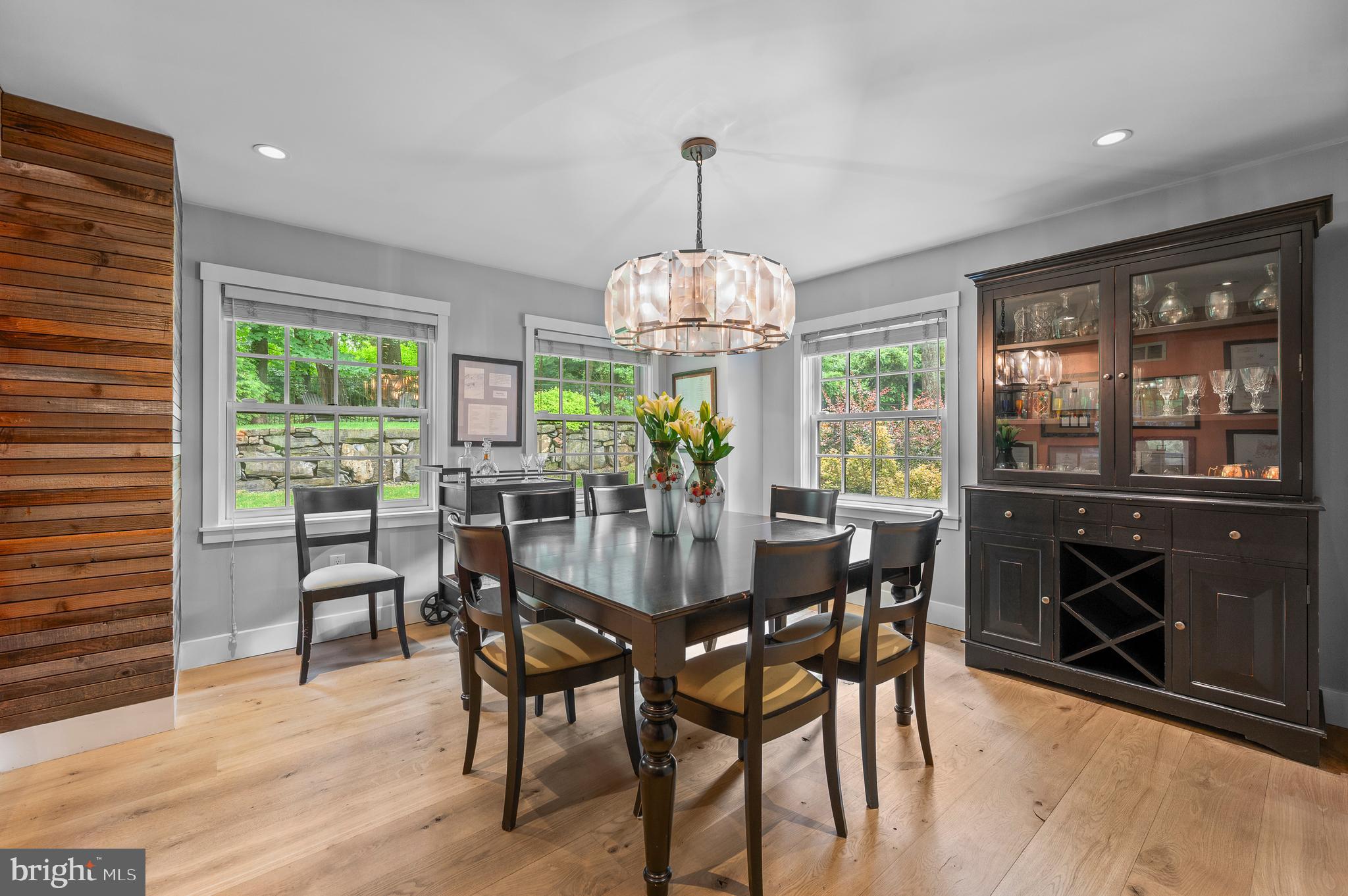 25 Bodine Road Berwyn, PA 19312 - Photo 15 of 73 a dining room with wooden floor a chandelier a wooden table and chairs