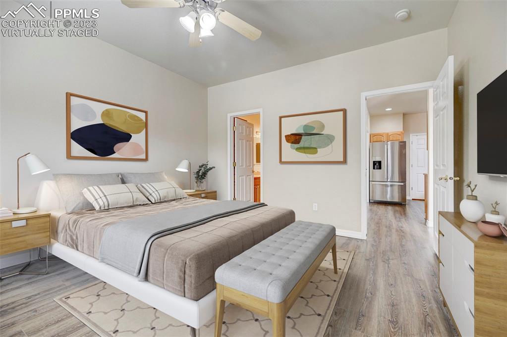 2170 Alpine Shadows View Colorado Springs, CO 80919 - Photo 12 of 49 a bedroom with a bed and a chandelier