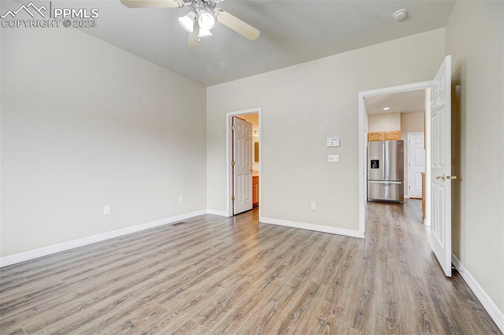 2170 Alpine Shadows View Colorado Springs, CO 80919 - Photo 13 of 49 wooden floor in an empty room with a window