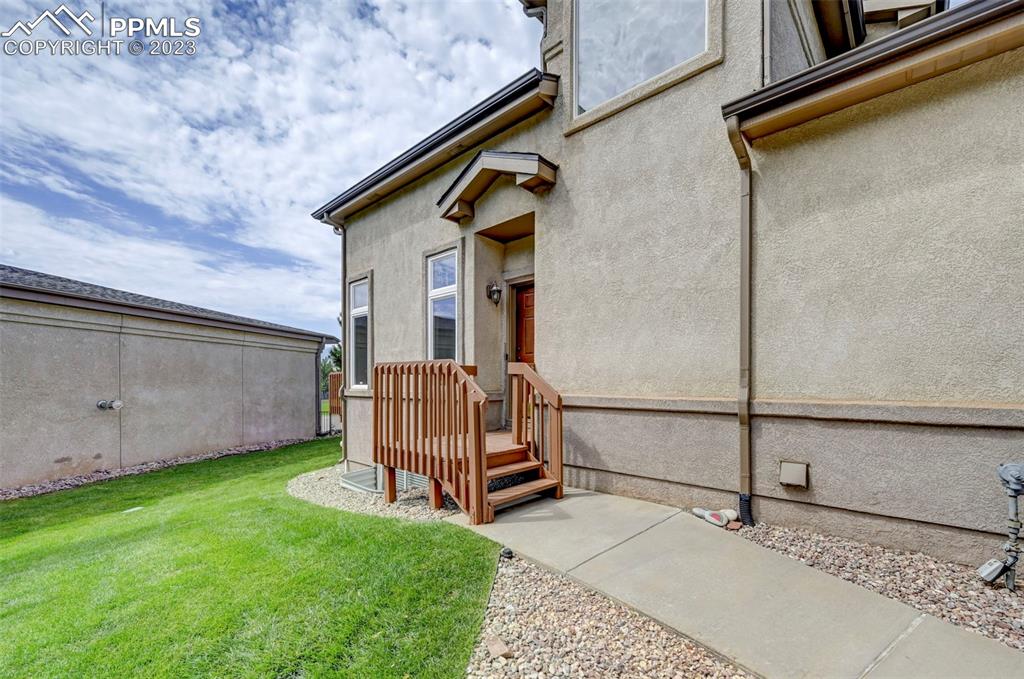 2170 Alpine Shadows View Colorado Springs, CO 80919 - Photo 14 of 49 a backyard of a house with two chairs and a barbeque