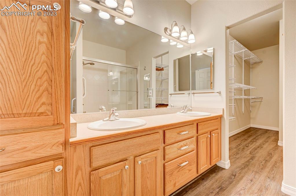 2170 Alpine Shadows View Colorado Springs, CO 80919 - Photo 29 of 49 a spacious bathroom with a granite countertop sink a mirror and a shower