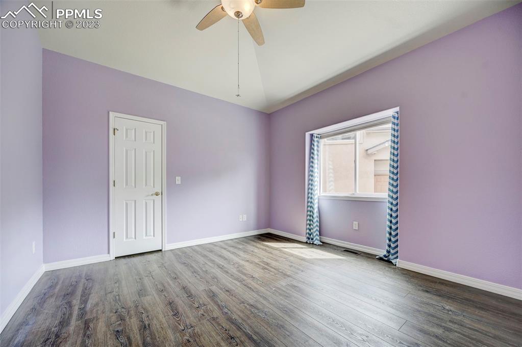 2170 Alpine Shadows View Colorado Springs, CO 80919 - Photo 33 of 49 an empty room with wooden floor closet and windows