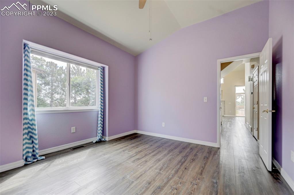 2170 Alpine Shadows View Colorado Springs, CO 80919 - Photo 34 of 49 an empty room with wooden floor and windows