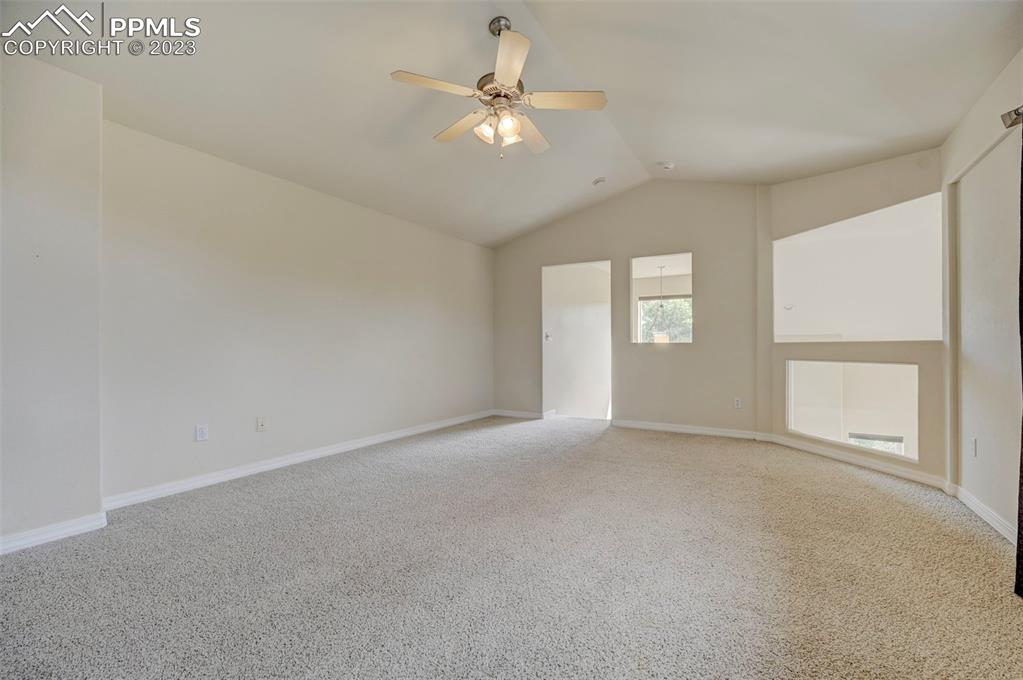 2170 Alpine Shadows View Colorado Springs, CO 80919 - Photo 36 of 49 an empty room with windows and ceiling fan