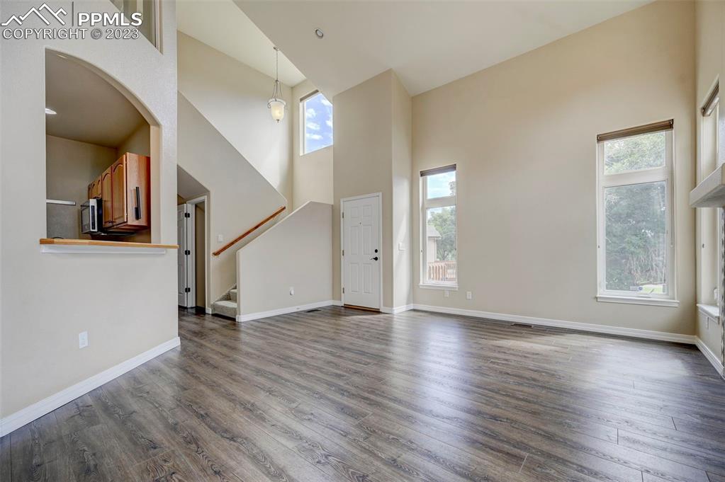 2170 Alpine Shadows View Colorado Springs, CO 80919 - Photo 5 of 49 a view of a hallway with wooden floor and a window