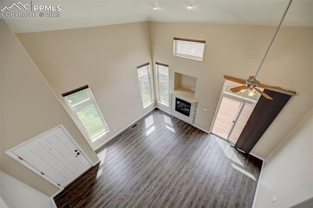 2170 Alpine Shadows View Colorado Springs, CO 80919 - Photo 7 of 49 a view of an empty room with wooden floor and a window