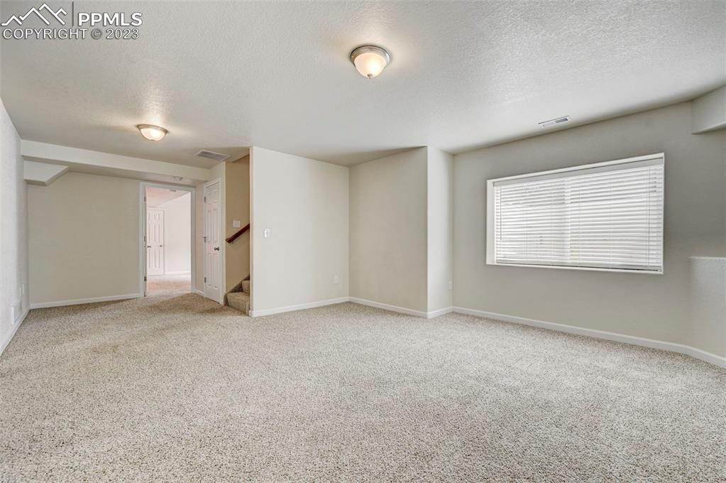 2170 Alpine Shadows View Colorado Springs, CO 80919 - Photo 9 of 49 an empty room with a empty space and windows