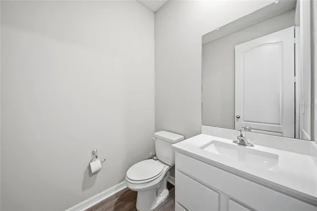 a bathroom with a sink toilet and a mirror