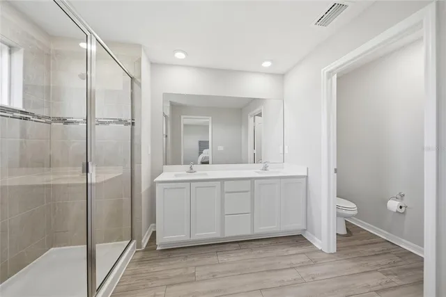 a bathroom with a double vanity sink and a mirror