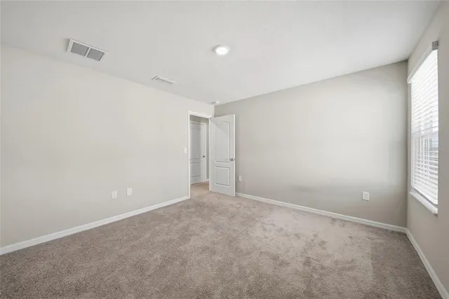 a view of an empty room and a window