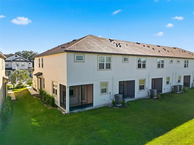 a view of house with backyard