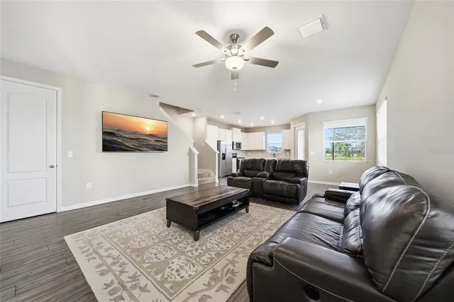 a living room with furniture and a chandelier