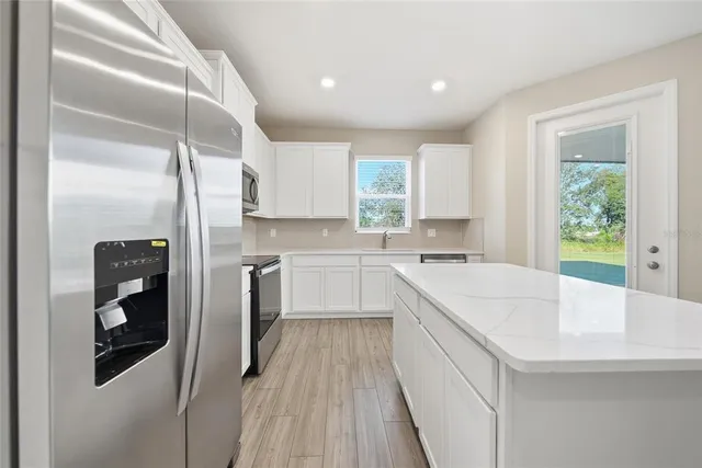 a kitchen with a sink a refrigerator a washer and dryer
