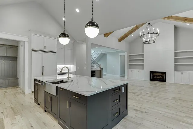 a bathroom with a white tub a sink and a window