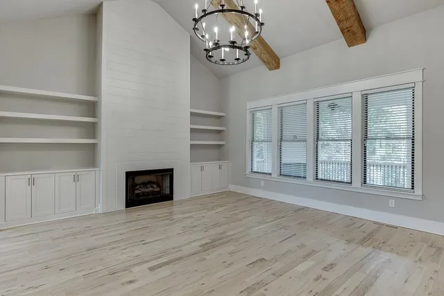 a kitchen with granite countertop a sink cabinets and wooden floor