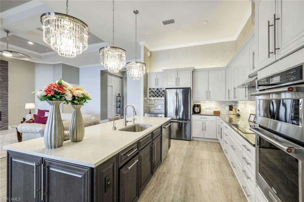 9075 Breakwater Drive Naples, FL 34120 - Photo 12 of 48 a kitchen with cabinets and stainless steel appliances