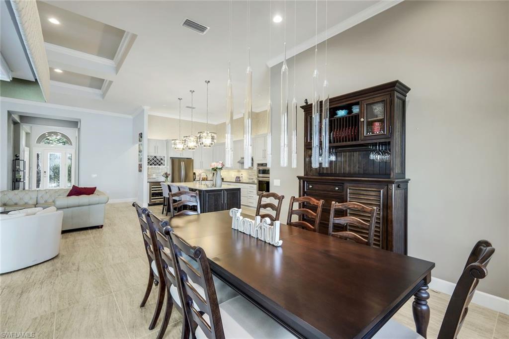 9075 Breakwater Drive Naples, FL 34120 - Photo 13 of 48 a view of a dining room with furniture