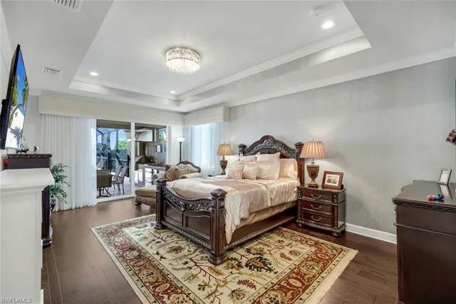 a spacious bedroom with a bed a couch and dresser