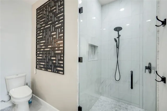 a bathroom with a toilet and shower