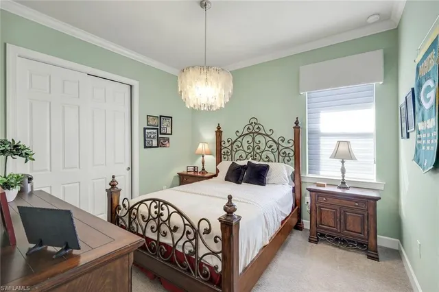 a bedroom with a bed and a chandelier