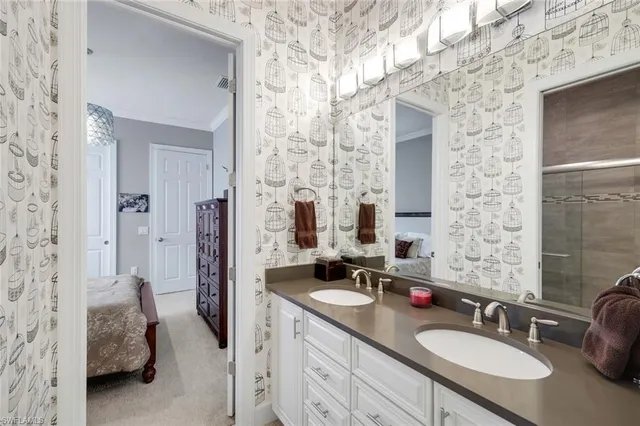 a en suite bathroom with a sink double vanity and shower