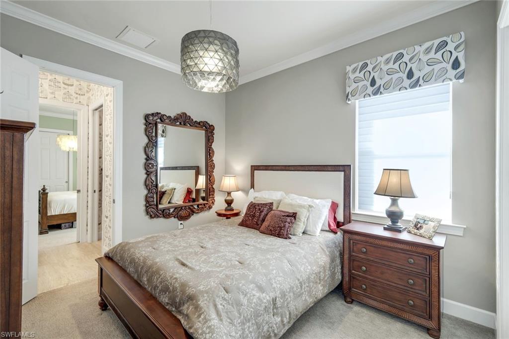 9075 Breakwater Drive Naples, FL 34120 - Photo 22 of 48 a bedroom with bed and window