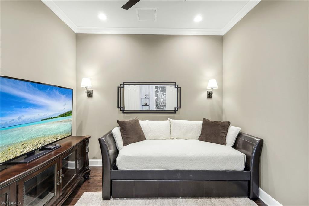 9075 Breakwater Drive Naples, FL 34120 - Photo 24 of 48 a bedroom with a bed and a flat screen tv