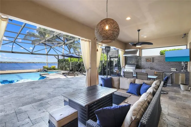 a outdoor dining space with furniture and chandelier