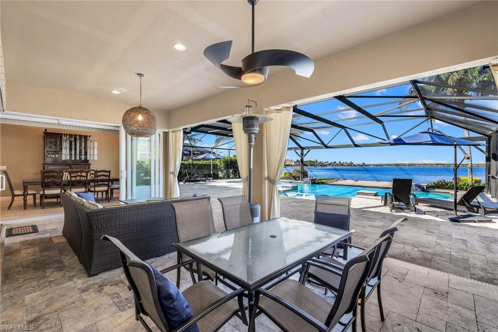 9075 Breakwater Drive Naples, FL 34120 - Photo 29 of 48 a view of a dining room with furniture window and wooden floor
