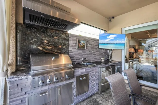 a kitchen with stainless steel appliances granite countertop a stove and a sink